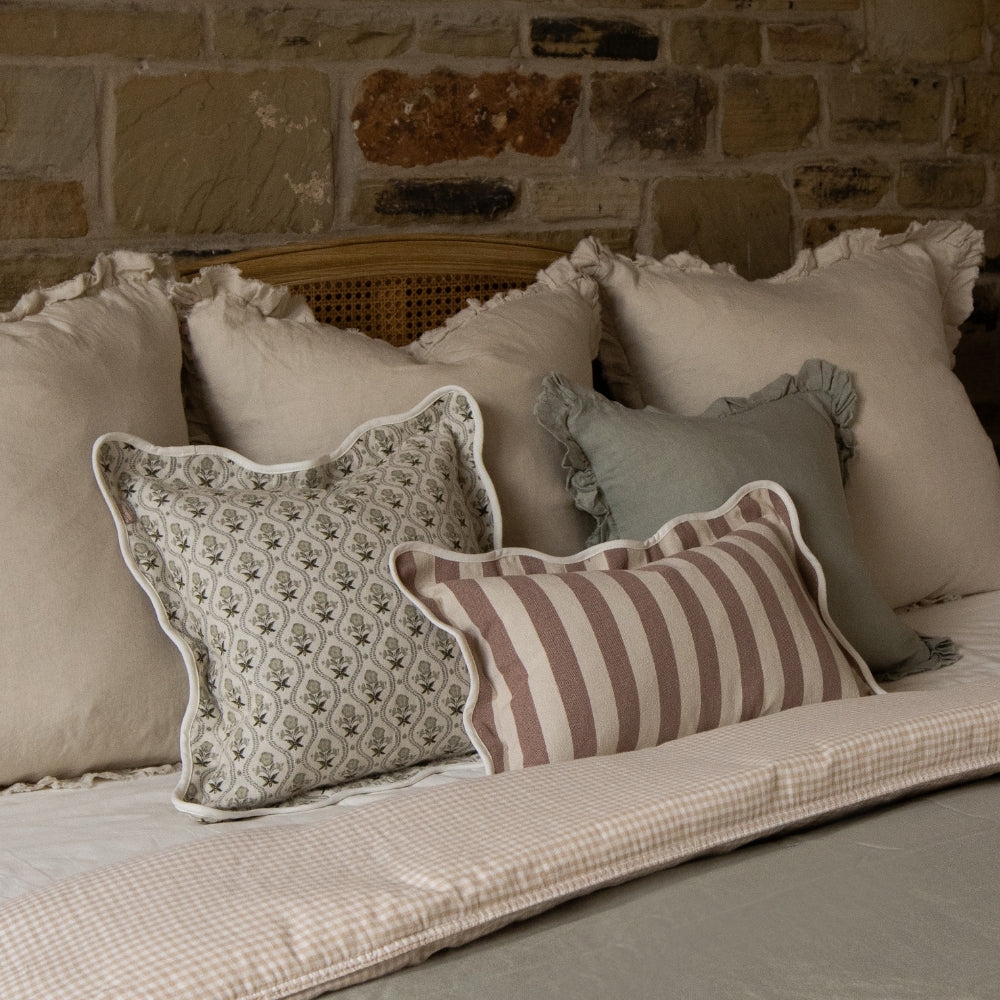scalloped Edge cushions on a bed 