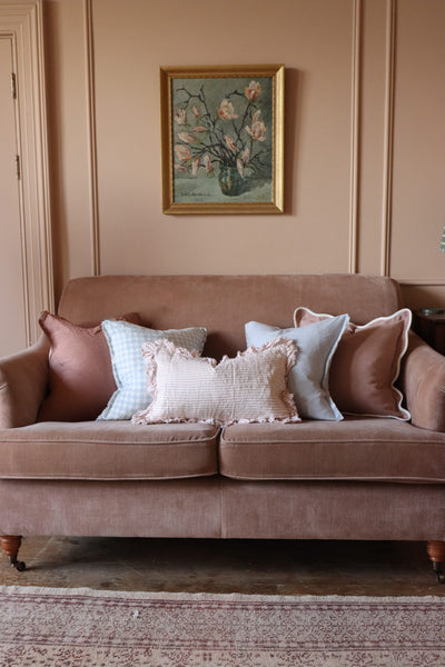 Pink and Blue Cushions on a Sofa