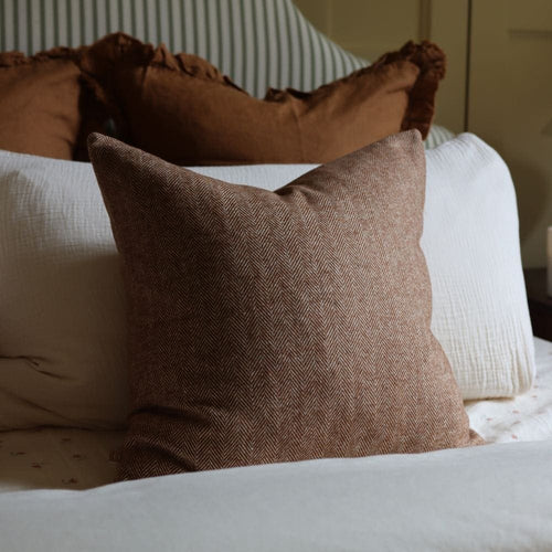tia rust herringbone cushion